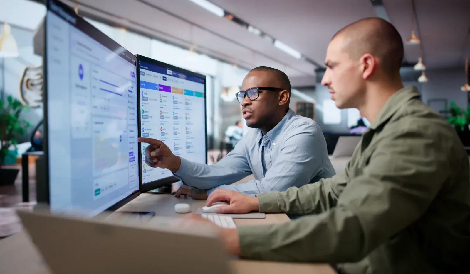 Two researchers reviewing study data on screen together