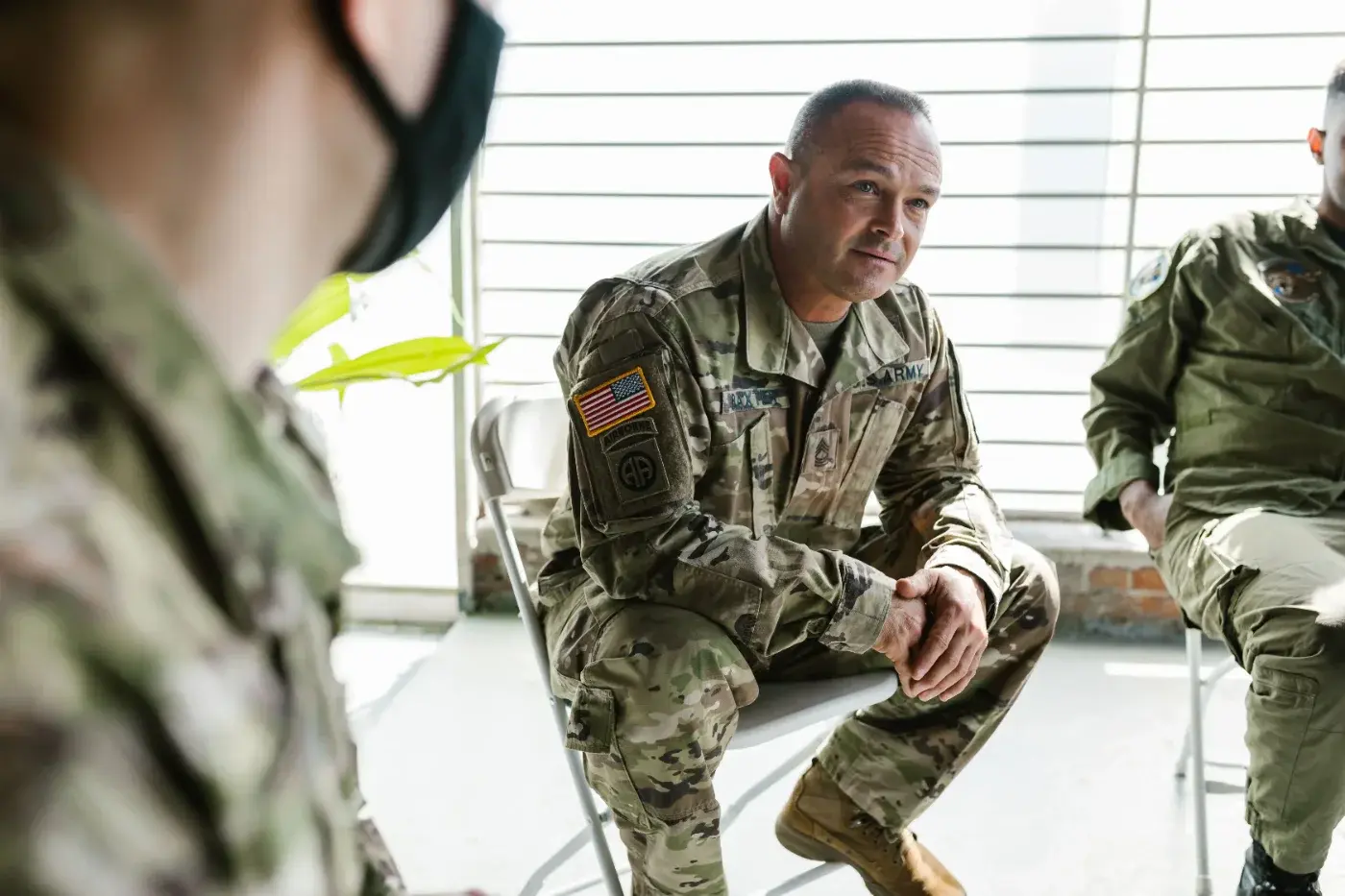 Service members seated in a group discussion