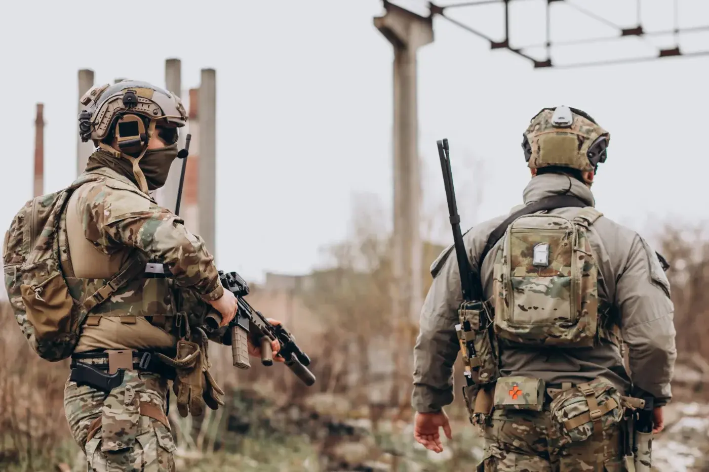 Two service members on patrol in the field